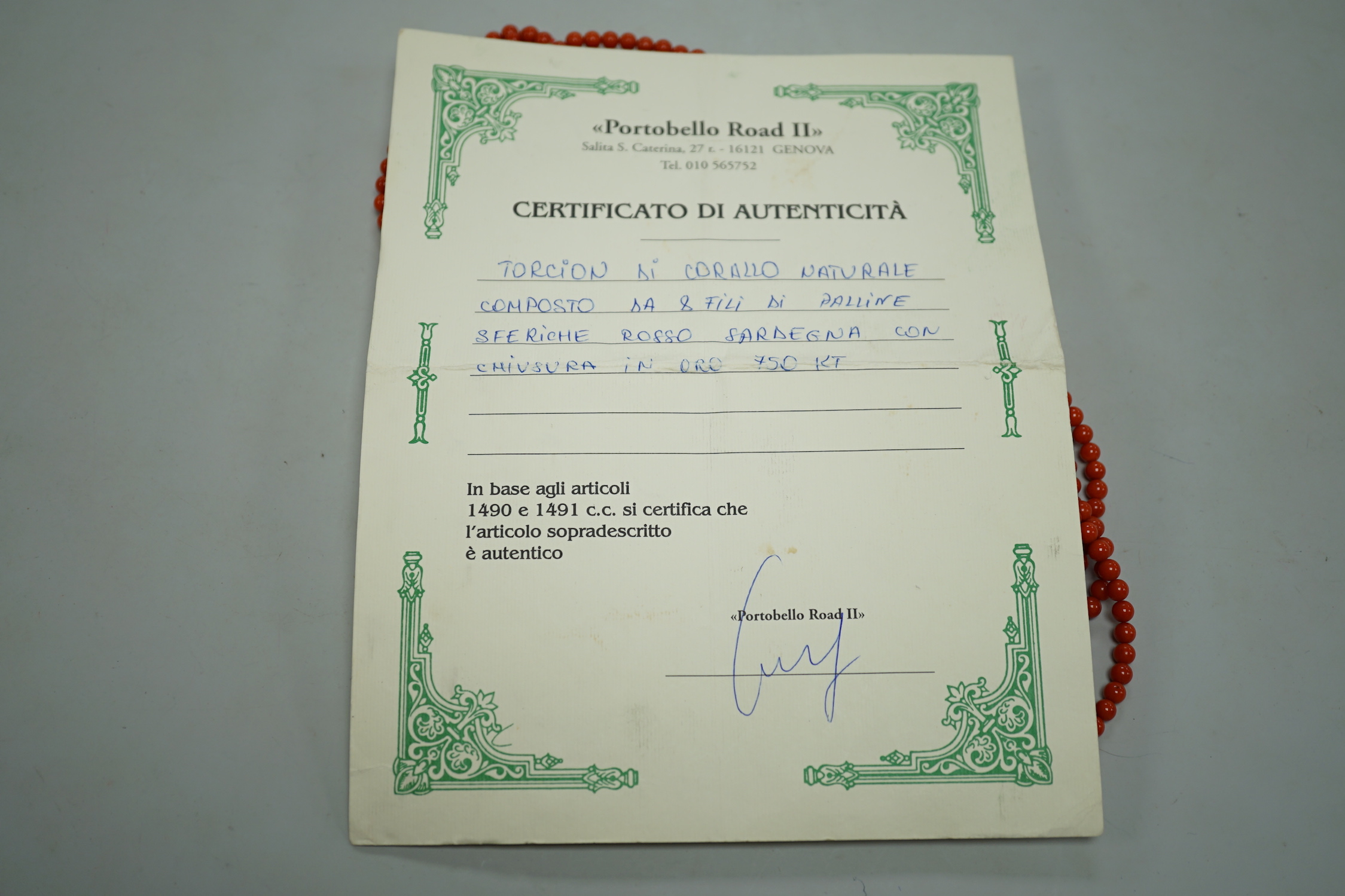 A 1980's Italian multi strand coral bead necklace, with 750 yellow metal clasp and Certificate of Authenticity, 50cm.